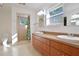 Double vanity bathroom with wood cabinets, tile floors and a shower at 510 Wideview Ave, Tarpon Springs, FL 34689