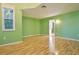 Light green bedroom with wood floors and a view of the backyard at 510 Wideview Ave, Tarpon Springs, FL 34689