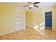 Yellow bedroom with wood floors, built-in shelves, and a closet at 510 Wideview Ave, Tarpon Springs, FL 34689