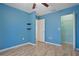 Light blue bedroom with wood floors and a spacious closet at 510 Wideview Ave, Tarpon Springs, FL 34689