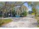 Two-story yellow house with a large front yard and mature trees at 510 Wideview Ave, Tarpon Springs, FL 34689