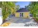 Bright yellow guest house with double doors and adjacent patio at 510 Wideview Ave, Tarpon Springs, FL 34689