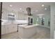 Modern kitchen featuring white cabinets, island, and stainless steel appliances at 510 Wideview Ave, Tarpon Springs, FL 34689