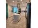 Modern white kitchen with large island and stainless steel appliances at 510 Wideview Ave, Tarpon Springs, FL 34689