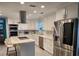 Modern white kitchen with large island and stainless steel appliances at 510 Wideview Ave, Tarpon Springs, FL 34689
