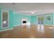 Living room with hardwood floors, fireplace, and access to balcony at 510 Wideview Ave, Tarpon Springs, FL 34689