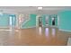 Open living room with hardwood floors, teal walls, and a staircase at 510 Wideview Ave, Tarpon Springs, FL 34689