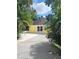 Bright yellow pool house near the pool at 510 Wideview Ave, Tarpon Springs, FL 34689