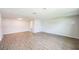 Large living area with light walls and wood-look floors at 6250 Kentfield Ave, New Port Richey, FL 34653