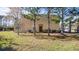 Rear exterior of home, showing a well-maintained lawn and access to the property at 12843 Buffalo Run Dr, Gibsonton, FL 33534