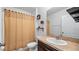 Bathroom featuring vanity sink, toilet, and tan shower curtain at 12843 Buffalo Run Dr, Gibsonton, FL 33534