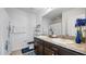 Bathroom with double sink vanity, shower with curtain, and blue accents at 12843 Buffalo Run Dr, Gibsonton, FL 33534