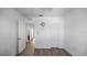 Bedroom with wood floors, open doorway, and white trim at 12843 Buffalo Run Dr, Gibsonton, FL 33534