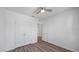 Bedroom with wood floors, ceiling fan, and double door closet at 12843 Buffalo Run Dr, Gibsonton, FL 33534