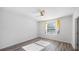 Cozy bedroom with a ceiling fan, a large window providing lots of natural light and wood flooring at 12843 Buffalo Run Dr, Gibsonton, FL 33534