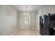 Eat-in dining space with a modern chandelier, neutral paint, natural lighting from a window and tile flooring at 12843 Buffalo Run Dr, Gibsonton, FL 33534