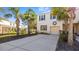 Inviting home features a two-car garage, well-kept lawn, and beautiful palm trees at 12843 Buffalo Run Dr, Gibsonton, FL 33534