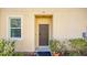 Home's front door is painted brown and is accented by green landscaping at 12843 Buffalo Run Dr, Gibsonton, FL 33534