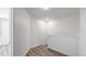 Upstairs hallway with wood floor, white walls, and stairway at 12843 Buffalo Run Dr, Gibsonton, FL 33534
