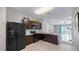 The kitchen features dark cabinetry, light countertops, stainless steel appliances, and a stainless steel sink at 12843 Buffalo Run Dr, Gibsonton, FL 33534