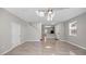 Spacious living room with tile flooring, staircase access, lots of natural light, and views into the kitchen at 12843 Buffalo Run Dr, Gibsonton, FL 33534