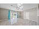 Living room with neutral walls, a ceiling fan, and access to a screened-in back patio through sliding glass doors at 12843 Buffalo Run Dr, Gibsonton, FL 33534
