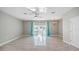 Living room featuring neutral walls, a chandelier, a ceiling fan, and access to the back patio through sliding glass doors at 12843 Buffalo Run Dr, Gibsonton, FL 33534