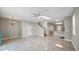 Large living room features a ceiling fan, tile floors, and access to dining and kitchen areas at 12843 Buffalo Run Dr, Gibsonton, FL 33534