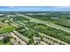 Aerial view of townhouses and a pond, with a highway nearby at 12843 Buffalo Run Dr, Gibsonton, FL 33534