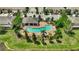 Community pool and clubhouse with surrounding landscaping at 12843 Buffalo Run Dr, Gibsonton, FL 33534