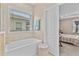 Bathroom with a bathtub, shower, and view of bedroom at 16831 Canopy Garden Dr, Port Charlotte, FL 33953