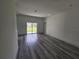 Open living area with gray flooring and sliding glass doors at 1378 Wilmette St, Port Charlotte, FL 33980