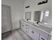 Double vanity bathroom with gray cabinets and quartz countertops at 1378 Wilmette St, Port Charlotte, FL 33980