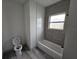 Clean bathroom with gray tile and a bathtub at 1378 Wilmette St, Port Charlotte, FL 33980