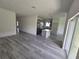 Living room with open concept kitchen and gray floors at 1378 Wilmette St, Port Charlotte, FL 33980
