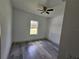 Bright bedroom featuring wood-look flooring and a ceiling fan at 1378 Wilmette St, Port Charlotte, FL 33980