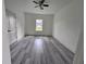 Spacious bedroom with gray vinyl plank flooring and a large window at 1378 Wilmette St, Port Charlotte, FL 33980