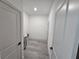 Clean hallway with gray floors and doors to other rooms at 1378 Wilmette St, Port Charlotte, FL 33980