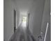 Bright hallway with grey vinyl plank flooring at 1378 Wilmette St, Port Charlotte, FL 33980