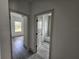 Open view of bedroom and bathroom with grey vinyl flooring at 1378 Wilmette St, Port Charlotte, FL 33980