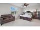 Spacious bedroom with a king-size bed, a couch, and a large window at 43317 Water Bird Way # 5021, Punta Gorda, FL 33982