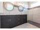 Modern bathroom boasts double sinks, granite counters, decorative mirrors, and a glass-enclosed shower at 5316 Altoona St, Sarasota, FL 34232