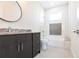 Well-lit bathroom featuring dark vanity with marble countertop, modern fixtures, and tiled shower at 5316 Altoona St, Sarasota, FL 34232