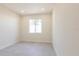Bright bedroom featuring a large window, neutral walls, and tile floors with modern finishes at 5316 Altoona St, Sarasota, FL 34232