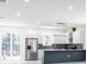 Bright, modern kitchen featuring stainless steel appliances, a breakfast bar, and sleek white cabinetry at 5316 Altoona St, Sarasota, FL 34232