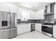 Modern kitchen features stainless steel appliances, granite countertops, custom cabinets, and a stylish backsplash at 5316 Altoona St, Sarasota, FL 34232