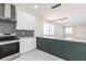 Modern kitchen featuring granite countertops, stainless steel appliances, and stylish two-tone cabinets at 5316 Altoona St, Sarasota, FL 34232