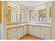 Double vanity bathroom with updated light fixtures at 35935 Tanda Cir, Zephyrhills, FL 33541