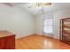 Second bedroom with hardwood floors and a built-in shelving unit at 35935 Tanda Cir, Zephyrhills, FL 33541