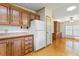 Kitchen with wood cabinets and white appliances at 35935 Tanda Cir, Zephyrhills, FL 33541